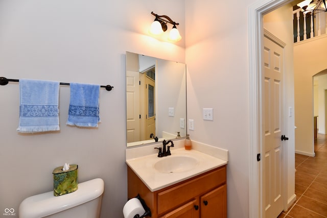 bathroom featuring tile patterned floors, vanity, and toilet