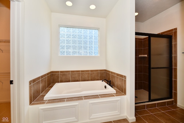 bathroom featuring tile patterned flooring and independent shower and bath