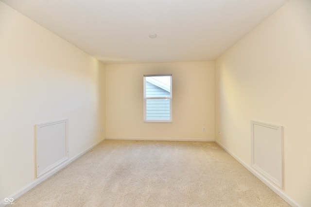 spare room with light carpet