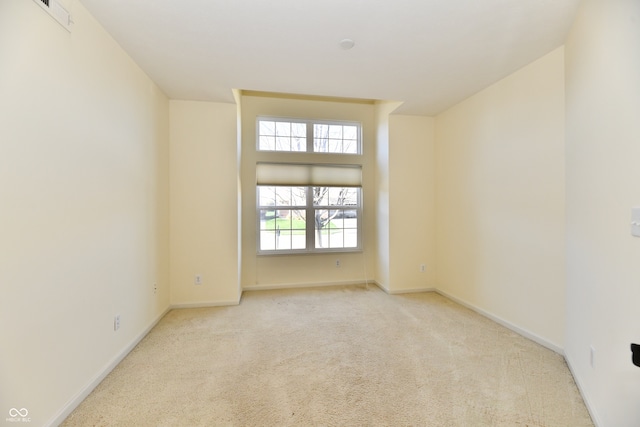 spare room featuring light carpet