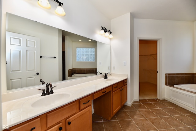 bathroom featuring tile patterned flooring, vanity, and a tub