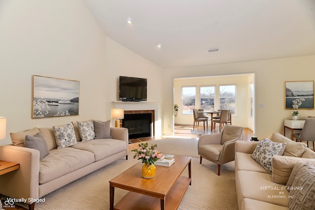 living room featuring high vaulted ceiling