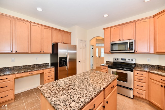 kitchen featuring stone counters, light brown cabinets, and appliances with stainless steel finishes