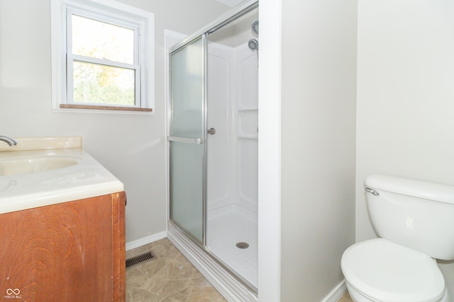 bathroom with vanity, toilet, and walk in shower