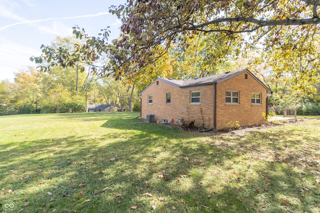 view of side of home with a yard