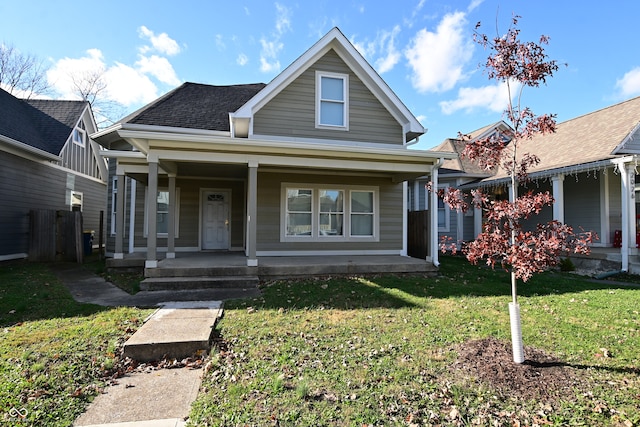 bungalow featuring a porch and a front yard