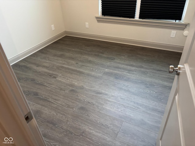 spare room featuring dark hardwood / wood-style flooring