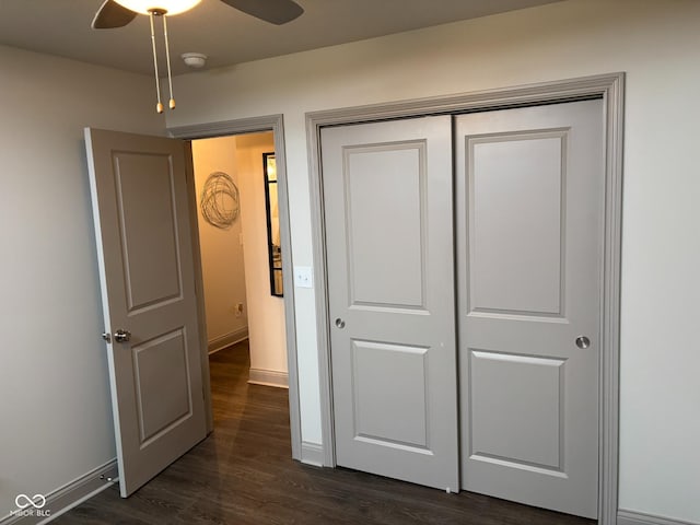 unfurnished bedroom with dark hardwood / wood-style floors, ceiling fan, and a closet