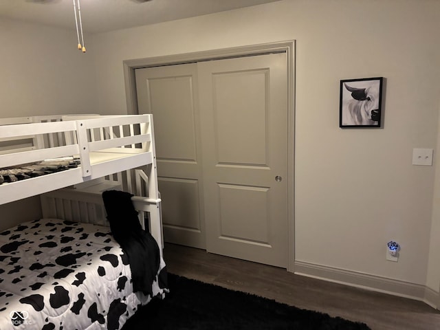 bedroom featuring dark hardwood / wood-style floors and a closet