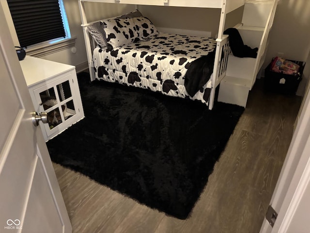 bedroom with dark hardwood / wood-style floors