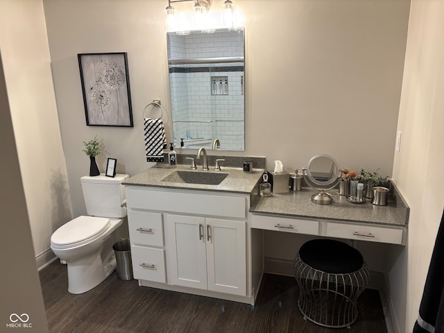 bathroom featuring hardwood / wood-style floors, vanity, toilet, and a shower with door