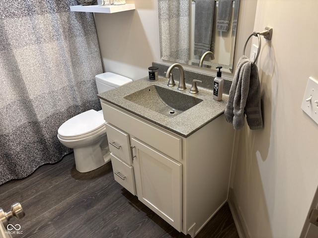 bathroom with a shower with curtain, vanity, toilet, and wood-type flooring