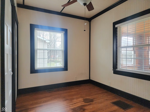 unfurnished room with dark hardwood / wood-style floors, ceiling fan, and ornamental molding