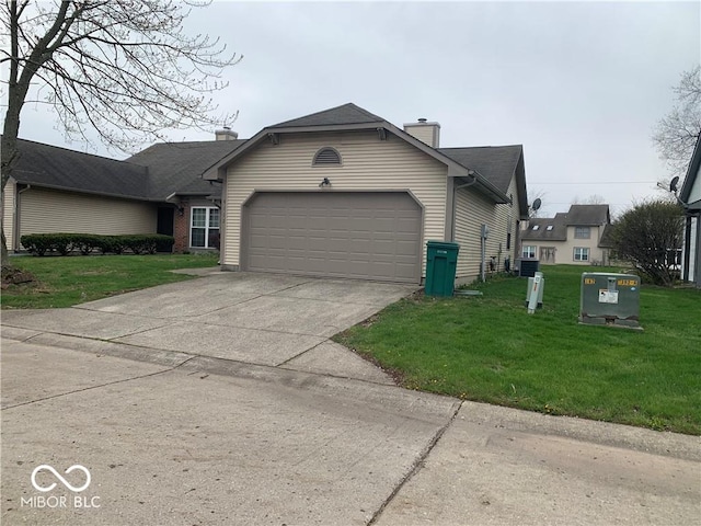 view of home's exterior with a garage and a lawn