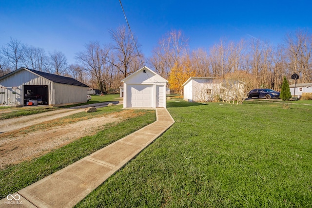 view of yard featuring an outbuilding and a garage