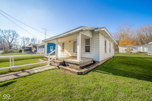 view of front of home with a porch and a front lawn