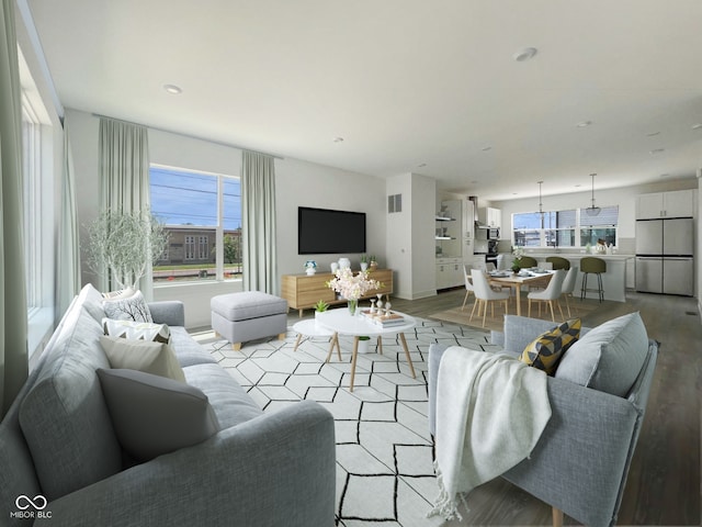 living room with light wood-type flooring and a wealth of natural light