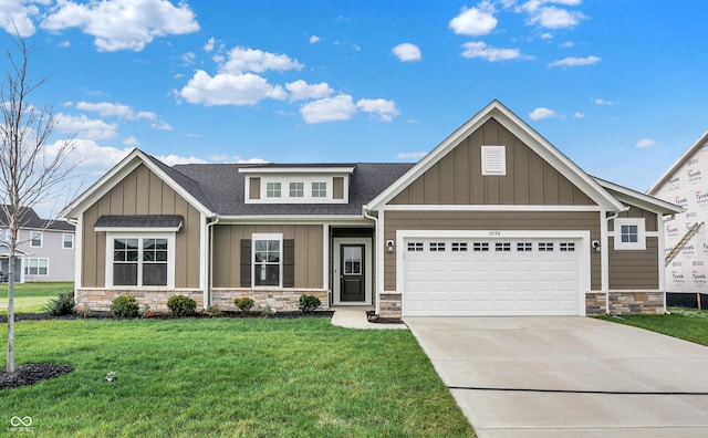 7098 Sterling Way, Brownsburg, IN 46112 - craftsman-style home featuring stone siding, an attached garage, a shingled roof, board and batten siding, and a front lawn