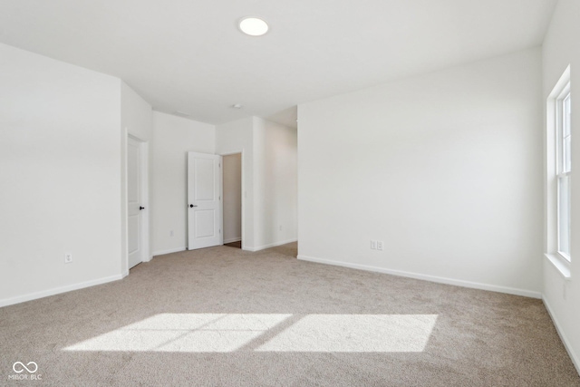 unfurnished room with light colored carpet