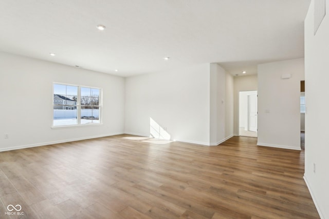 spare room featuring wood-type flooring