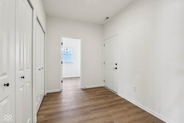 hallway featuring dark hardwood / wood-style flooring