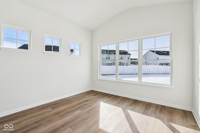 unfurnished room with vaulted ceiling and light hardwood / wood-style floors