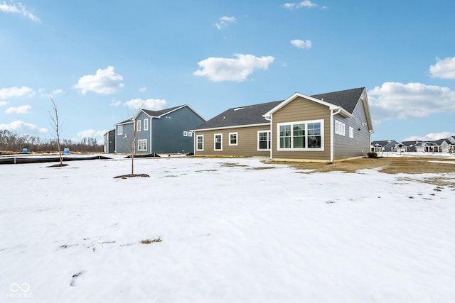 view of snow covered back of property