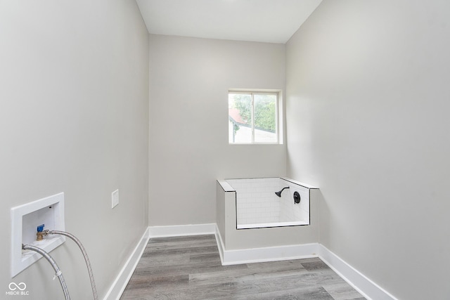 clothes washing area featuring hookup for a washing machine and wood-type flooring