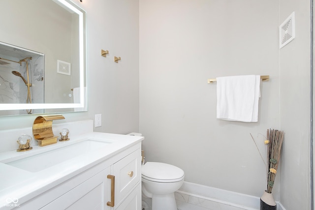 bathroom featuring tile patterned floors, toilet, vanity, and walk in shower