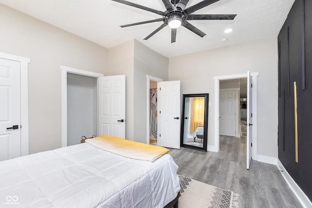 bedroom with light wood-type flooring and ceiling fan