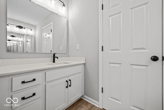 bathroom with vanity and hardwood / wood-style flooring