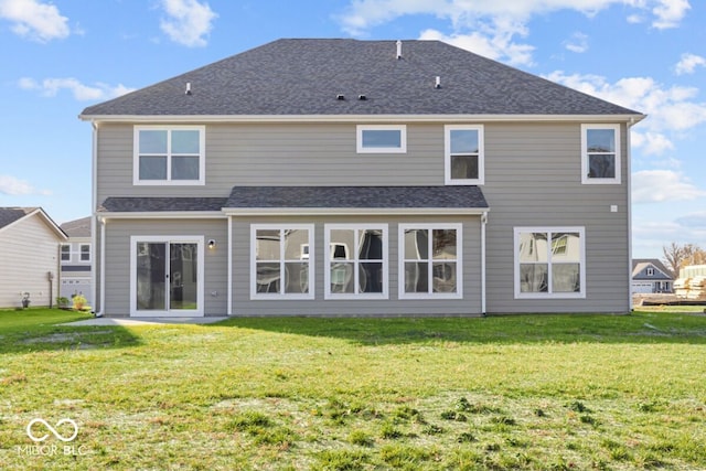 rear view of property featuring a yard