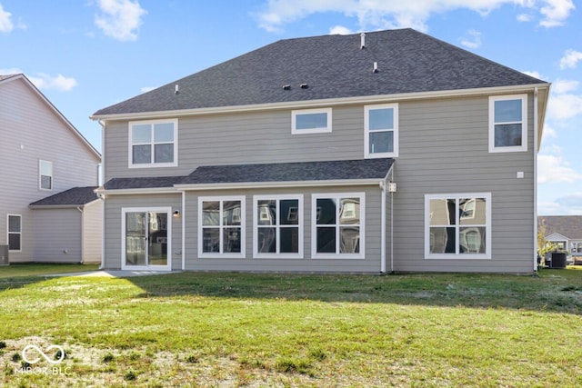 back of house with a lawn and central AC