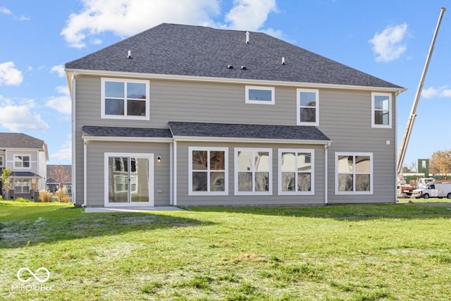 rear view of house with a lawn