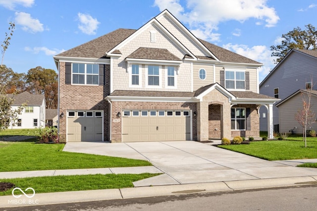 craftsman inspired home featuring a front lawn and a garage