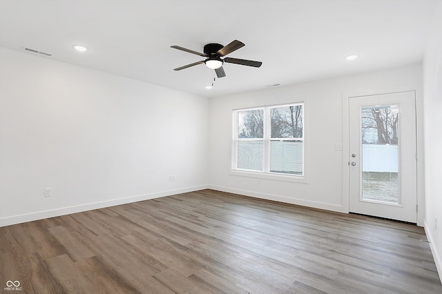 unfurnished room with ceiling fan and hardwood / wood-style floors