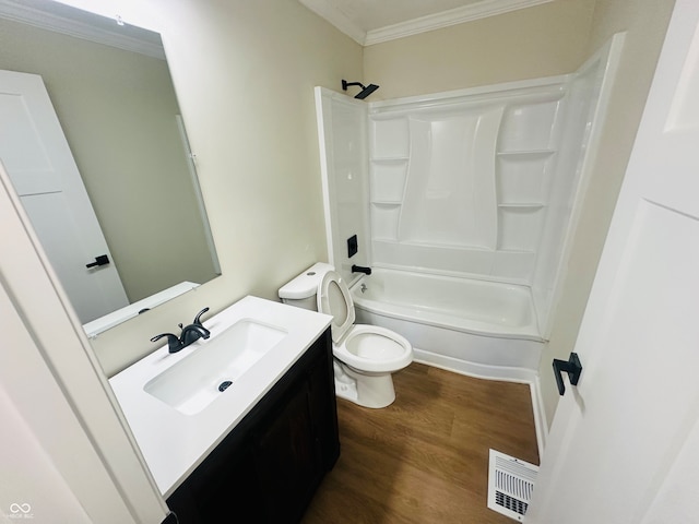 full bathroom featuring hardwood / wood-style floors, vanity, toilet, ornamental molding, and tub / shower combination