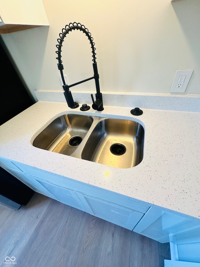 details featuring sink and hardwood / wood-style flooring