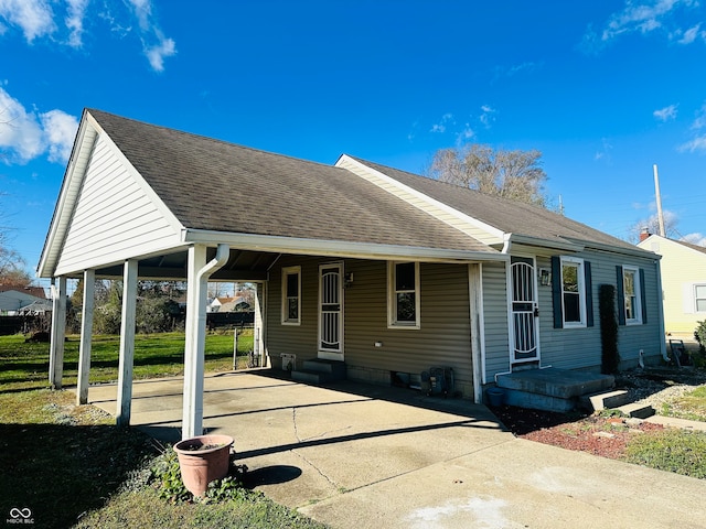 view of front of property with a front yard and a carport