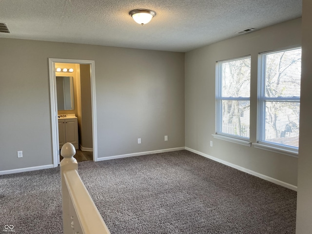 7530 Redcliff Rd, Indianapolis, IN 46256 - empty room featuring dark carpet, a textured ceiling, and baseboards