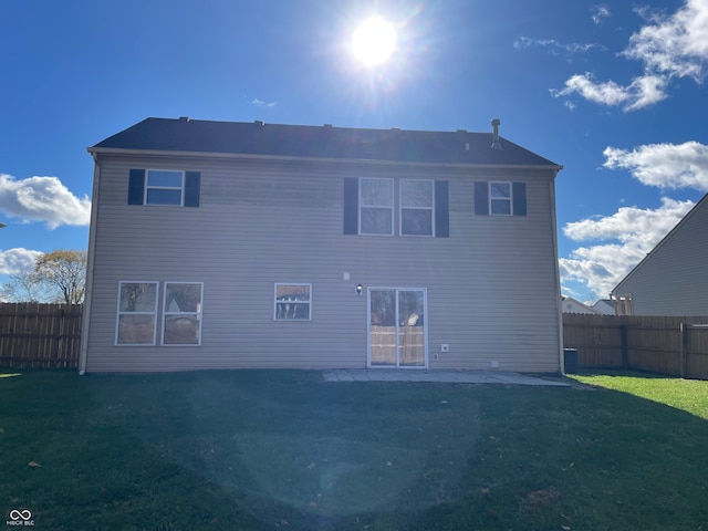 back of property featuring a lawn and a patio area