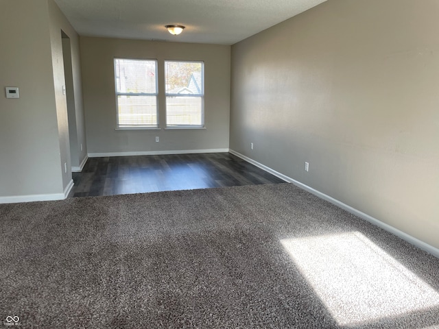 spare room featuring dark hardwood / wood-style floors