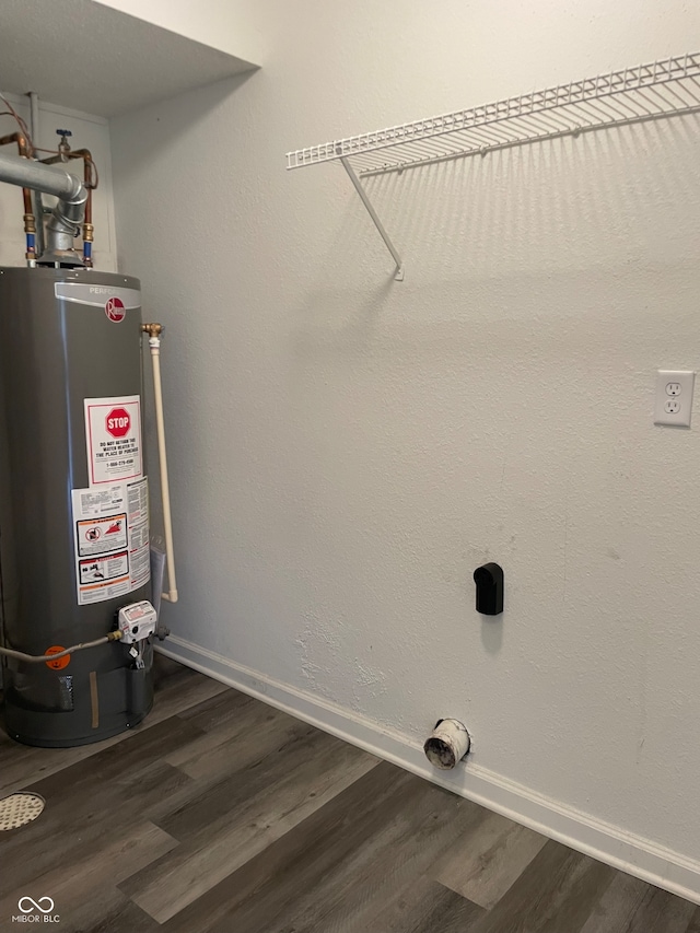 laundry area with water heater, dark hardwood / wood-style floors, and hookup for an electric dryer