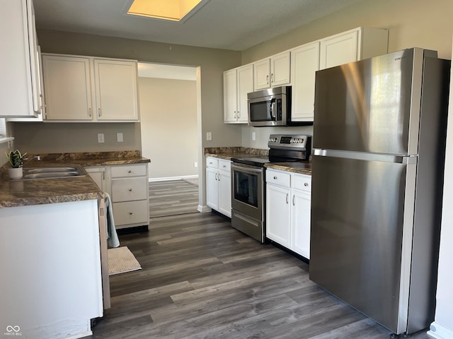 kitchen with white cabinets, sink, dark hardwood / wood-style flooring, and stainless steel appliances