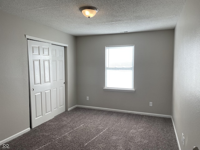 7530 Redcliff Rd, Indianapolis, IN 46256 - unfurnished bedroom with carpet, a textured ceiling, a closet, and baseboards
