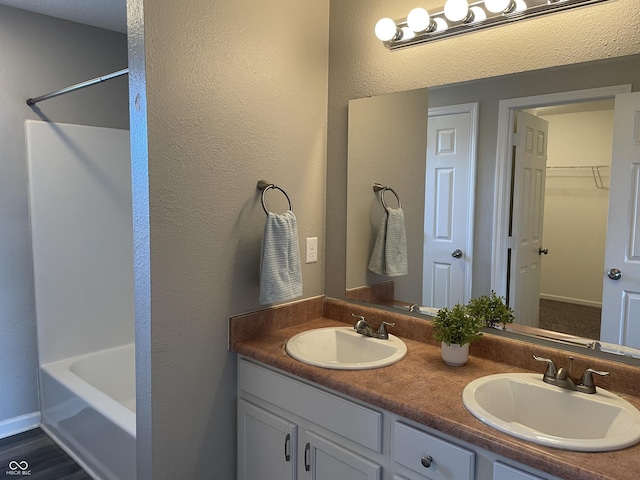 7530 Redcliff Rd, Indianapolis, IN 46256 - full bath with double vanity, a spacious closet, and a textured wall