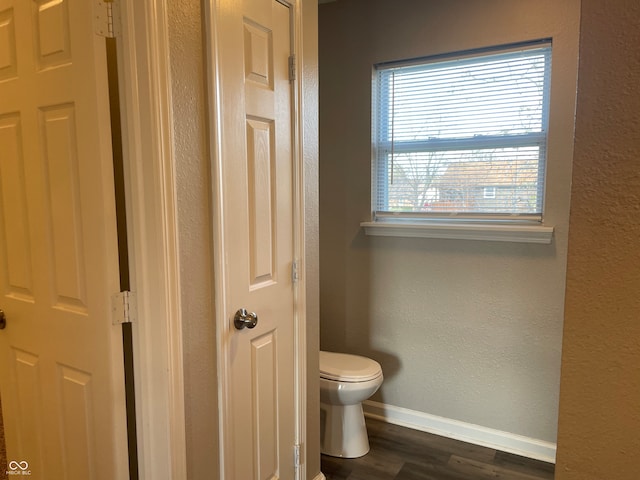 bathroom with hardwood / wood-style floors and toilet