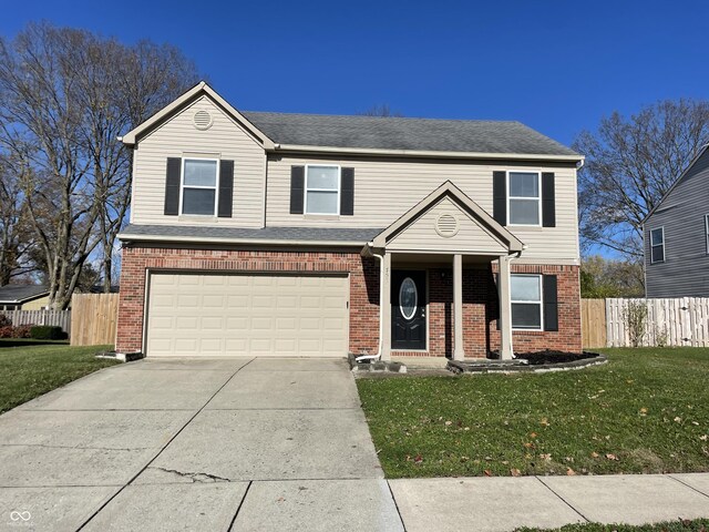 7530 Redcliff Rd, Indianapolis, IN 46256 - traditional-style house with a garage, driveway, brick siding, and covered porch