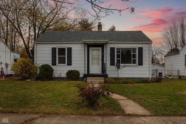 bungalow-style house featuring a yard