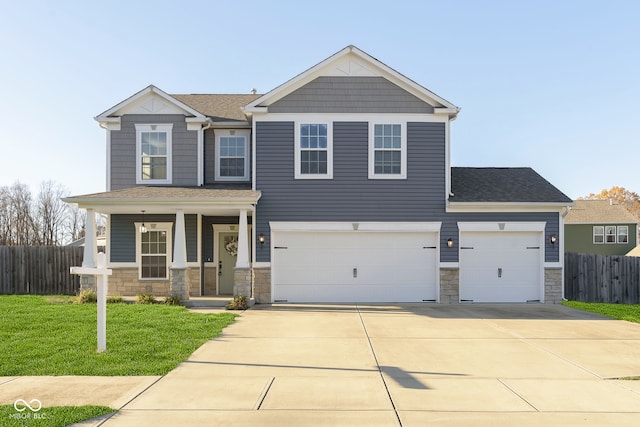 view of front of property with a garage and a front lawn